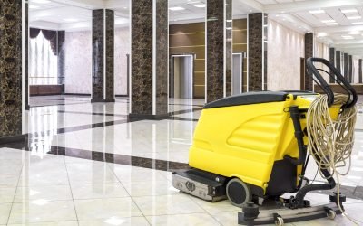 Cleaning machine in the empty office lobby Cleaning machine in the empty office lobby. Yellow vacuum equipment for cleaning is on the shiny marble floor. Concept of professional cleaning service.